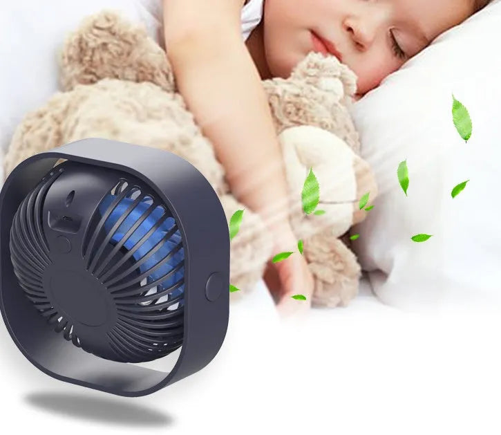 USB desk fan with 360-degree rotation in alarm clock style on a desk