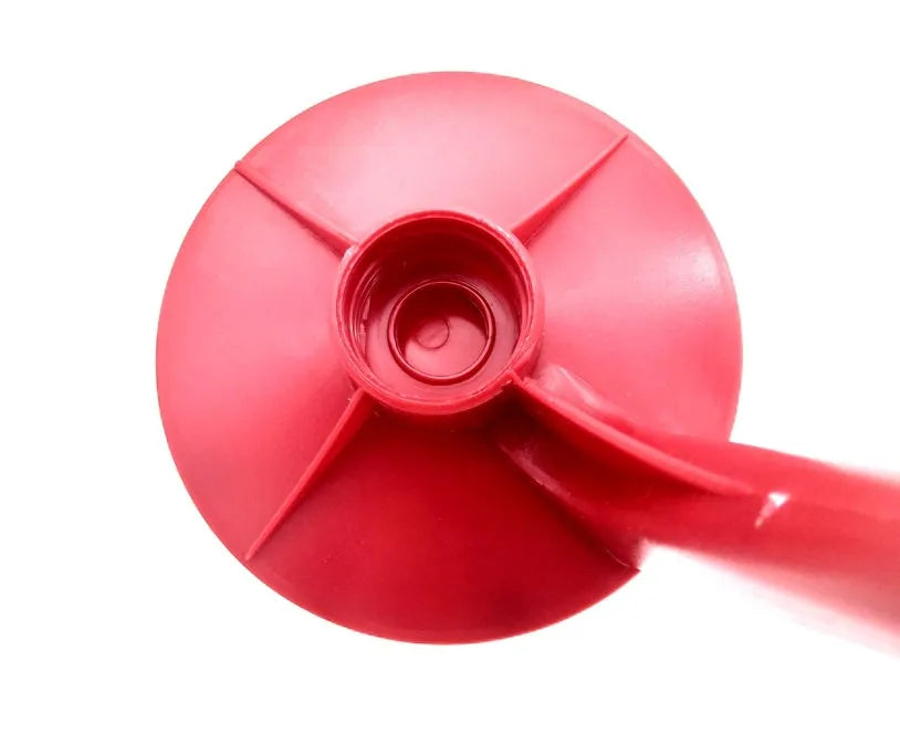 Red Magic Tap plastic soda dispenser attached to an inverted 2-litre bottle on a table.