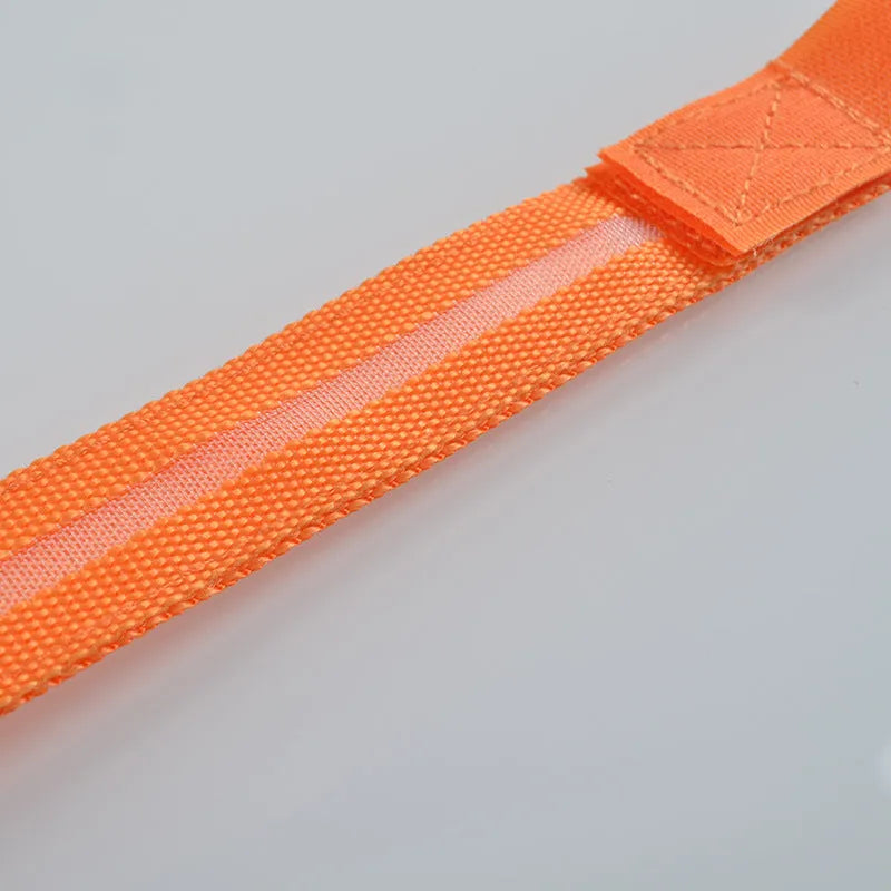 Illuminated arm band with LED lights on a black ribbon, adjustable, showing blue and red colours