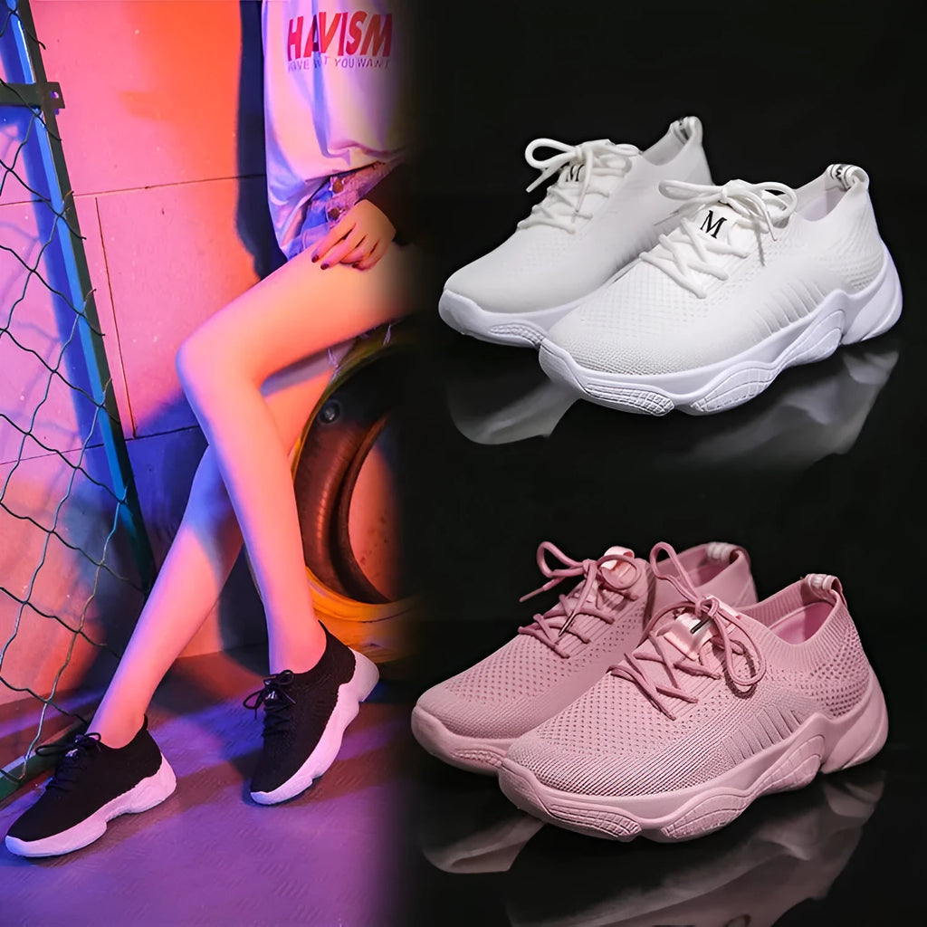 Women's white fly-knit sports shoes with thick rubber sole and front strap.