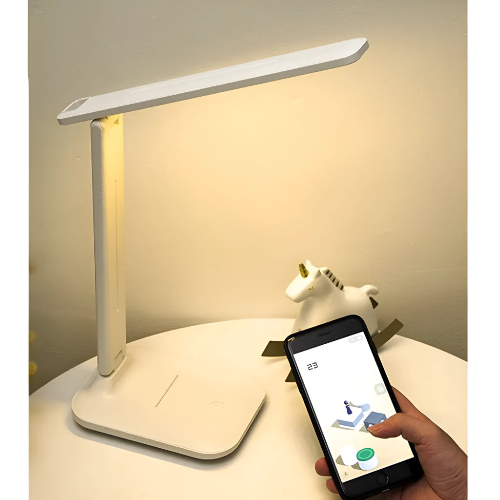 White USB rechargeable bedside lamp with touch dimming controls on a table.