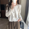Women's long-sleeved acrylic cardigan coat in light purple, shown with cardigan front open.