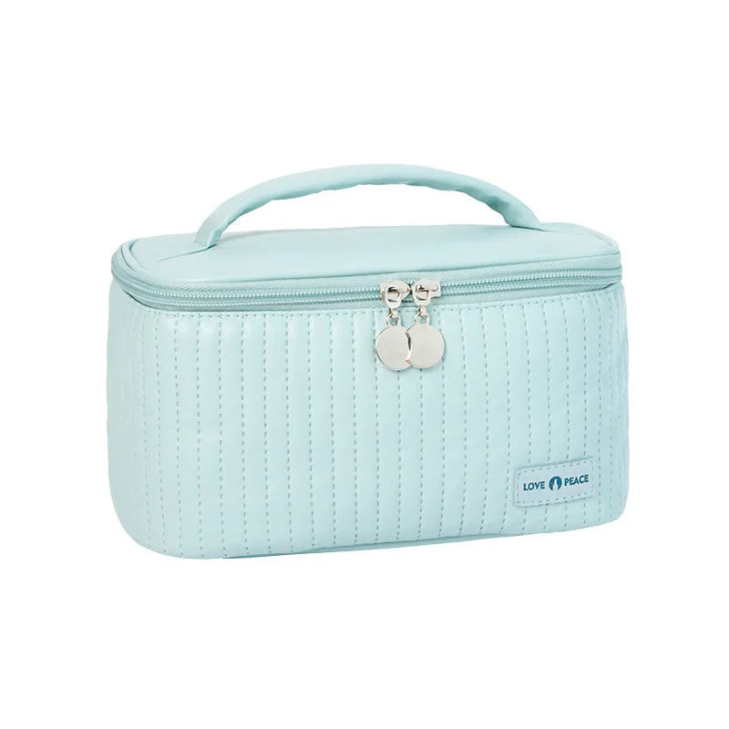 Open-top women's makeup bag in PU leather, shown in a light blue solid colour.