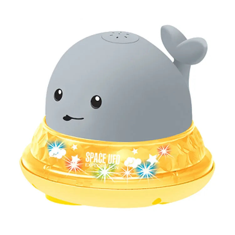 Grey and white whale bath toy spraying water with LED lights on water surface