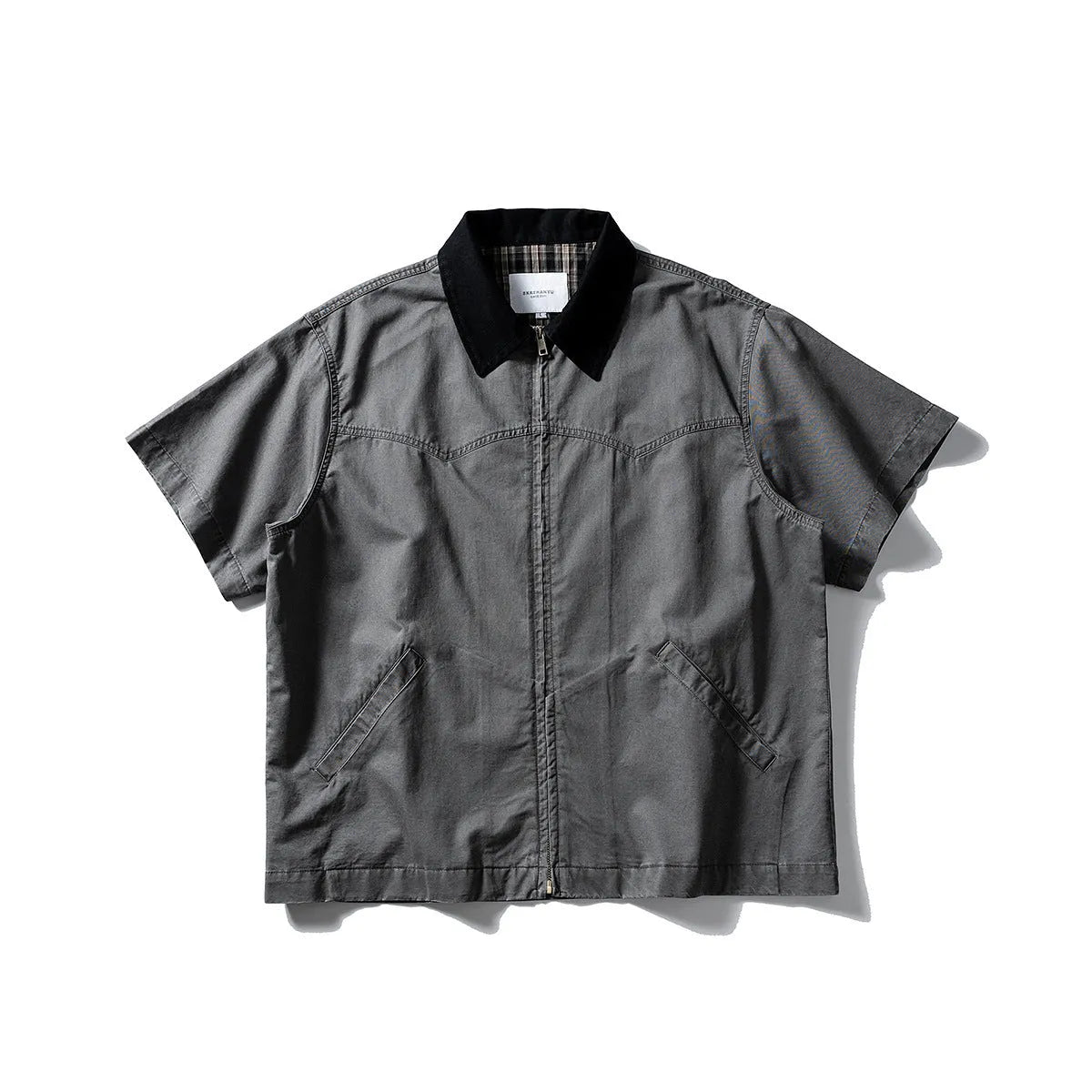 Short sleeve loose cotton overalls shirt in khaki colour on a hanger