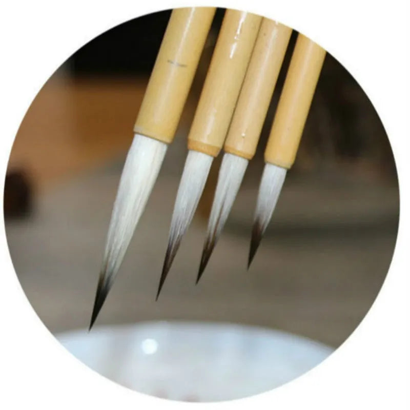 Set of four Chinese calligraphy brushes with gold pine branch design and mixed wolf hair and wool bristles