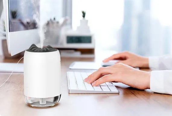 Mini cylindrical USB humidifier in turquoise green with water tank and mist outlet