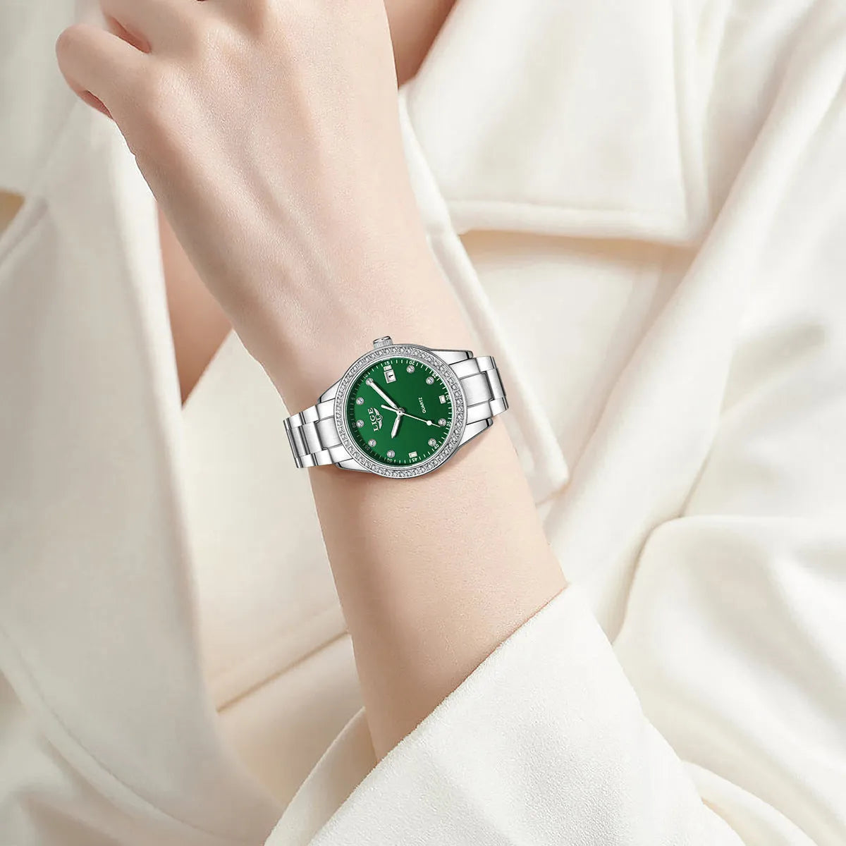 Women's silver stainless steel watch with diamond-encrusted bezel and luminous hands on a coloured dial.