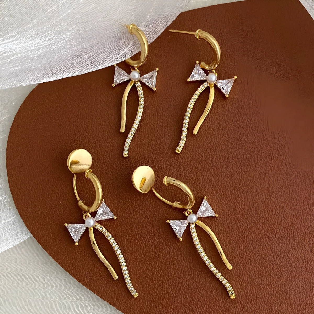 Asymmetric C-shaped copper earrings with inlaid zirconia stones, available as ear clips or ear studs for women.
