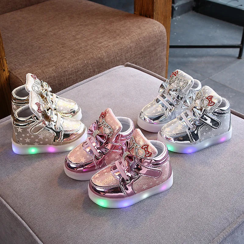 Golden, pink and silvery children's LED shoes with light-up soles, showing size chart from 21 to 30cm.