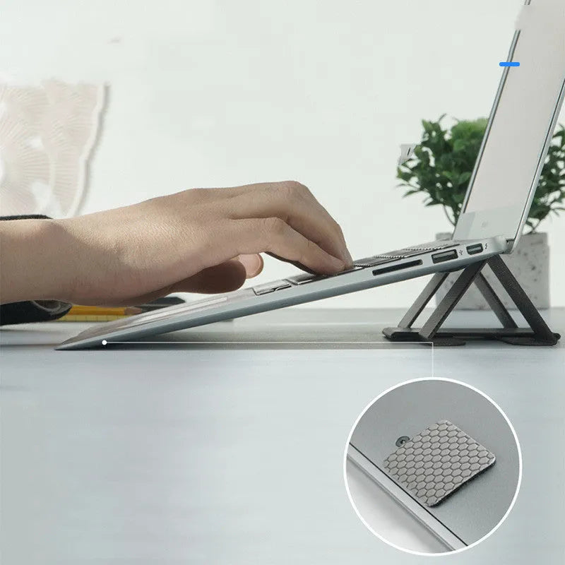 Ringke Folding Stand2 portable laptop stand in grey, folded open with a notebook placed on top