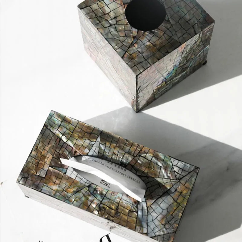 Black natural shell tissue storage box in rectangular and square shape options on a coffee table.