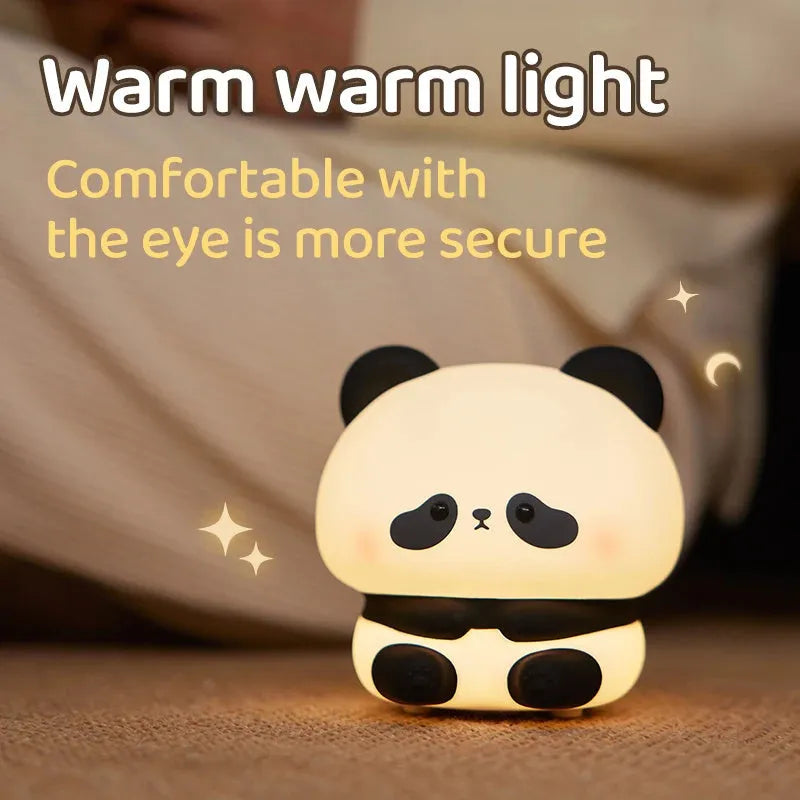 Cute panda LED night light with soft silicone cover, USB rechargeable, featuring colourful lighting modes on a bedside table.