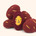 Red sweet potato shaped pet puzzle toy with hidden treat compartment and amusing face expression