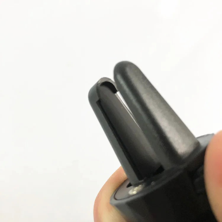 Matte black car phone holder clipped to vehicle air vent holding smartphone