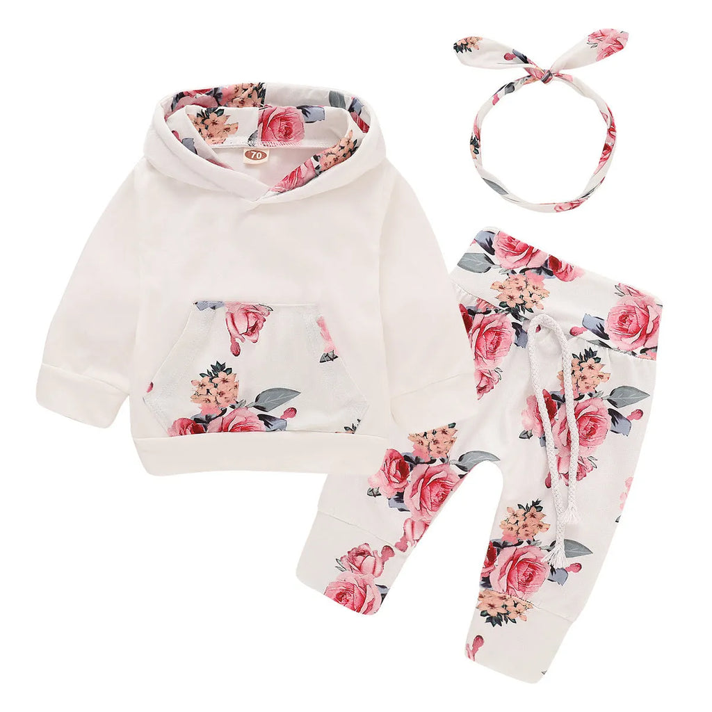 White cotton hooded tracksuit set for a baby girl, showing long sleeves and full-length trousers.