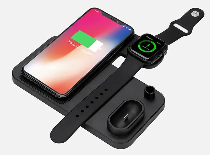 A white 4-in-1 wireless charger charging an iPhone and Apple Watch at an angle, with spots for AirPods and Apple Pencil.