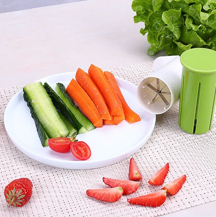 White handheld vegetable cutter with multiple stainless steel blades for slicing cucumbers, carrots, and strawberries.