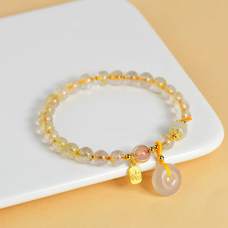Gold rutilated quartz geometric crystal bracelet with peace buckle safety clasp and pendant charm