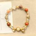 Gold-coloured hand-woven citrine bracelet with auspicious symbols and 8mm beads.