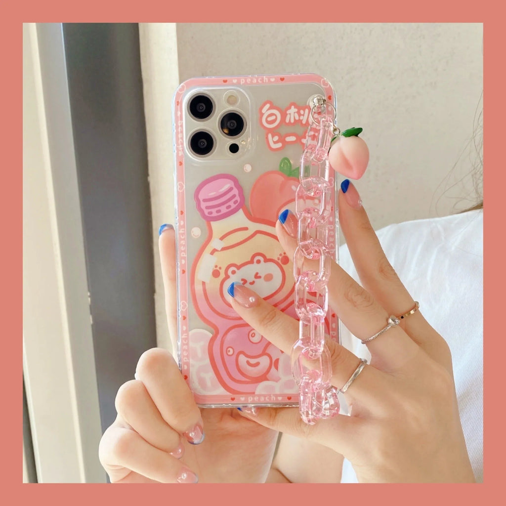 White silicone iPhone case with cartoon peach juice drink and bear design, shown with attached wrist strap.