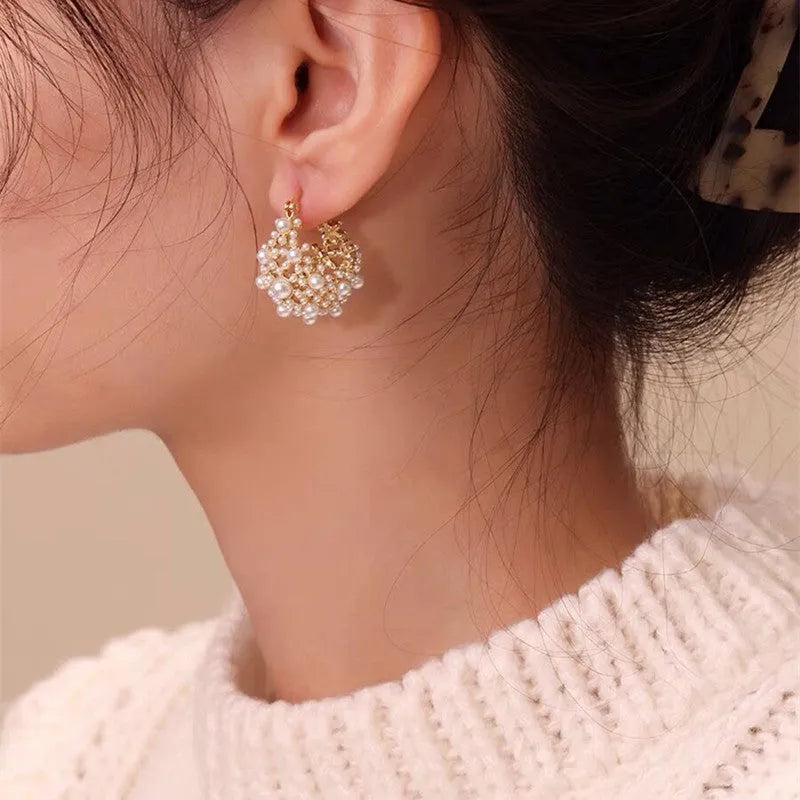 Gold women's earrings with flower basket design and small rice-shaped beads