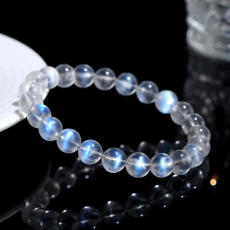 Blue Moonlight quartz bracelet with natural cream body beads on a white background.