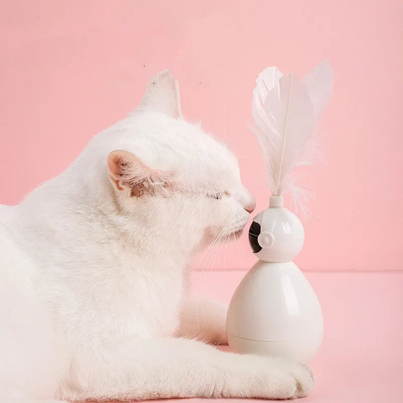 ABS tumbler cat toy with feather attachment in white colour, on a flat surface