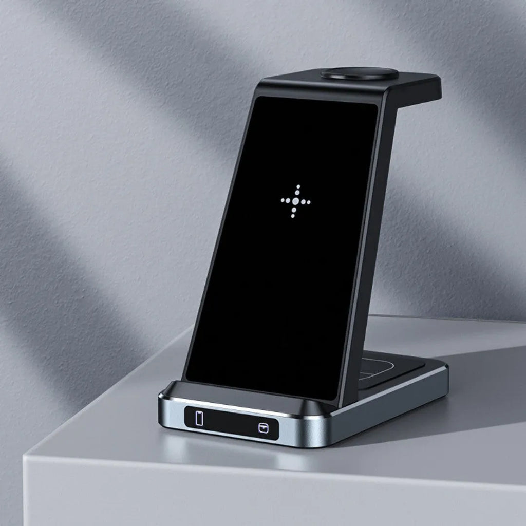 X2 three-in-one wireless charger in black charging a phone, watch, and earbuds on a desk