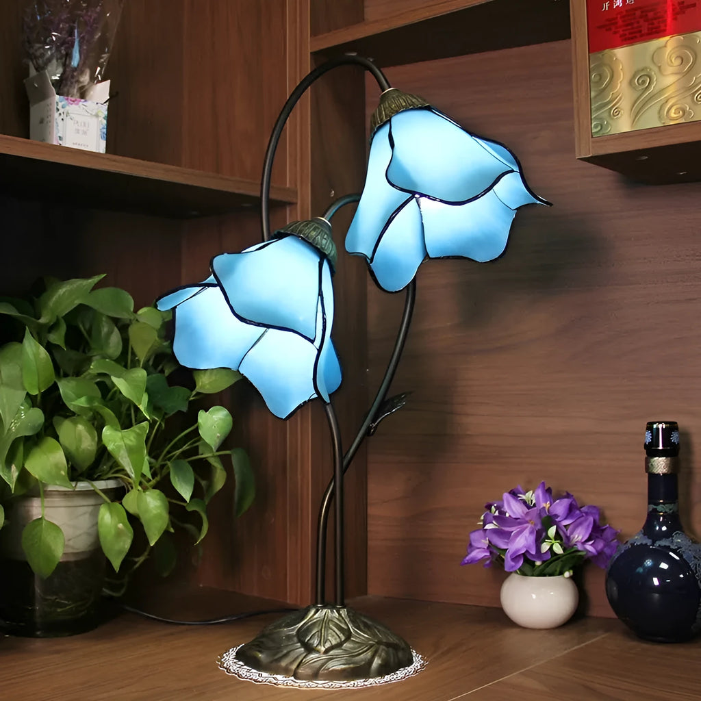 Retro American classical desk lamp with a decorative glass shade on a table.