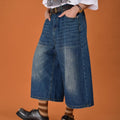 Men's loose-fit straight-leg denim shorts in a light blue wash on a hanger.
