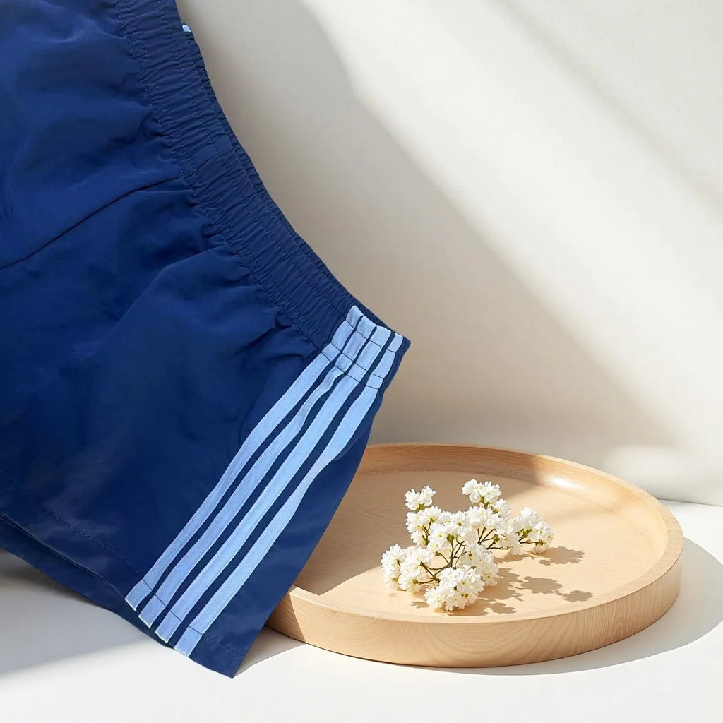 Men's navy blue high waist nylon sports shorts with micro elasticity on a white background