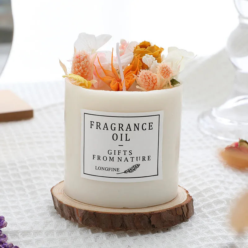 Decorative aromatherapy candle with dried flowers on a wood chip base, available in multiple scents.