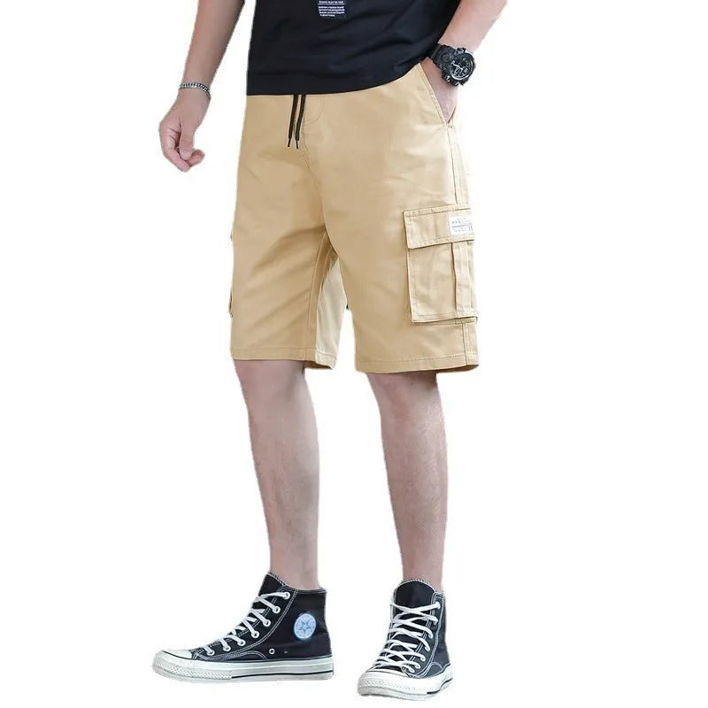 Man wearing loose fit khaki Korean style cargo trousers with a slim silhouette.