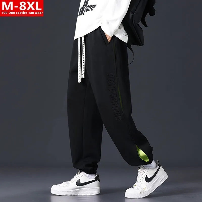 Men's loose fit cotton trousers with stitching detail and a banded ankle cuff.