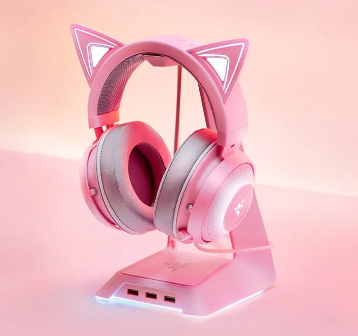 Pink glowing cat earphones wired USB headphones with LED cat ear lights on a plain background