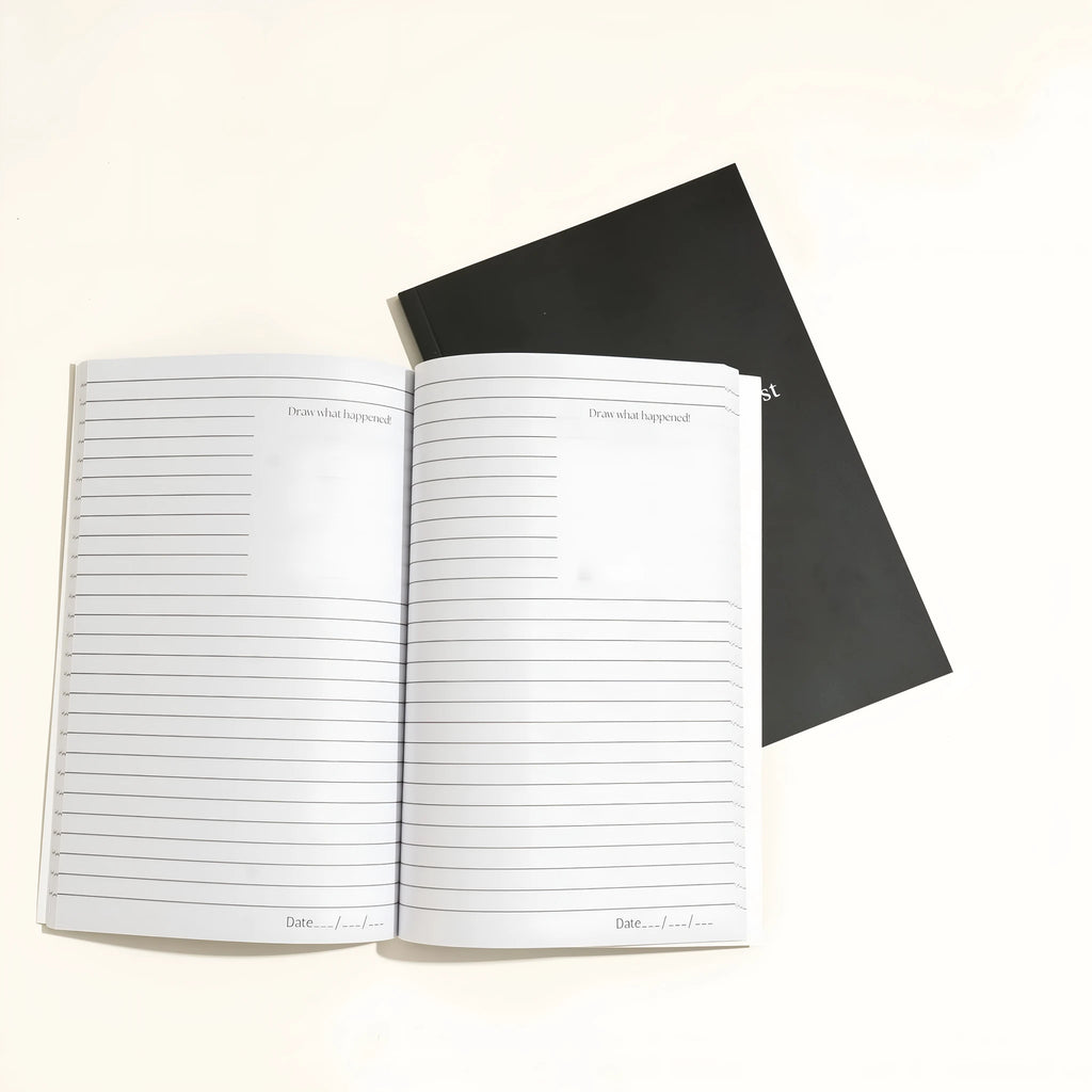 Black hardback A5 dream journal notebook with debossed title on soft-touch cover.