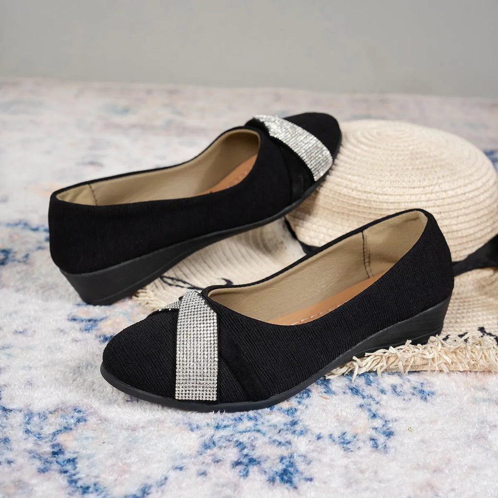 Women's black slip-on casual shoes with rhinestone decoration and a chunky heel.