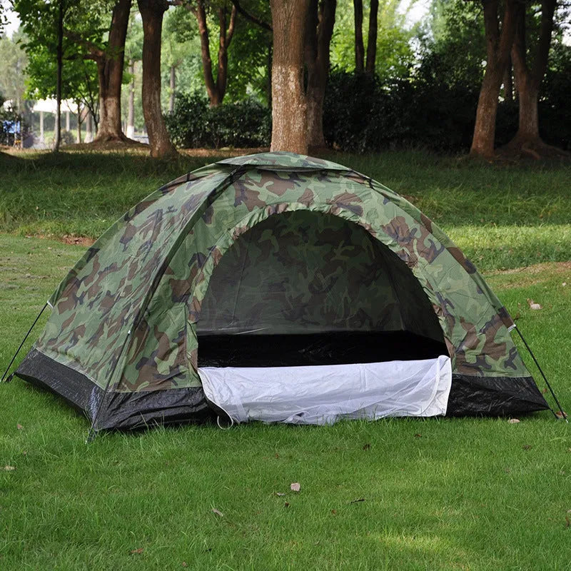 Green camouflage two-person tent with mesh windows, pitched outdoors.