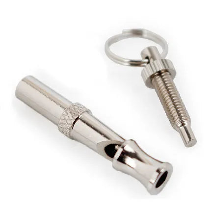 Silver ultrasonic adjustable dog training whistle made from stainless steel on a light background