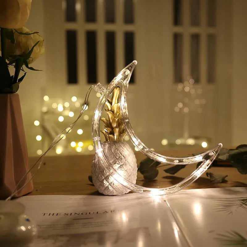 Battery powered LED decorative light with suction cups showing Santa Claus and snowman designs on a window.
