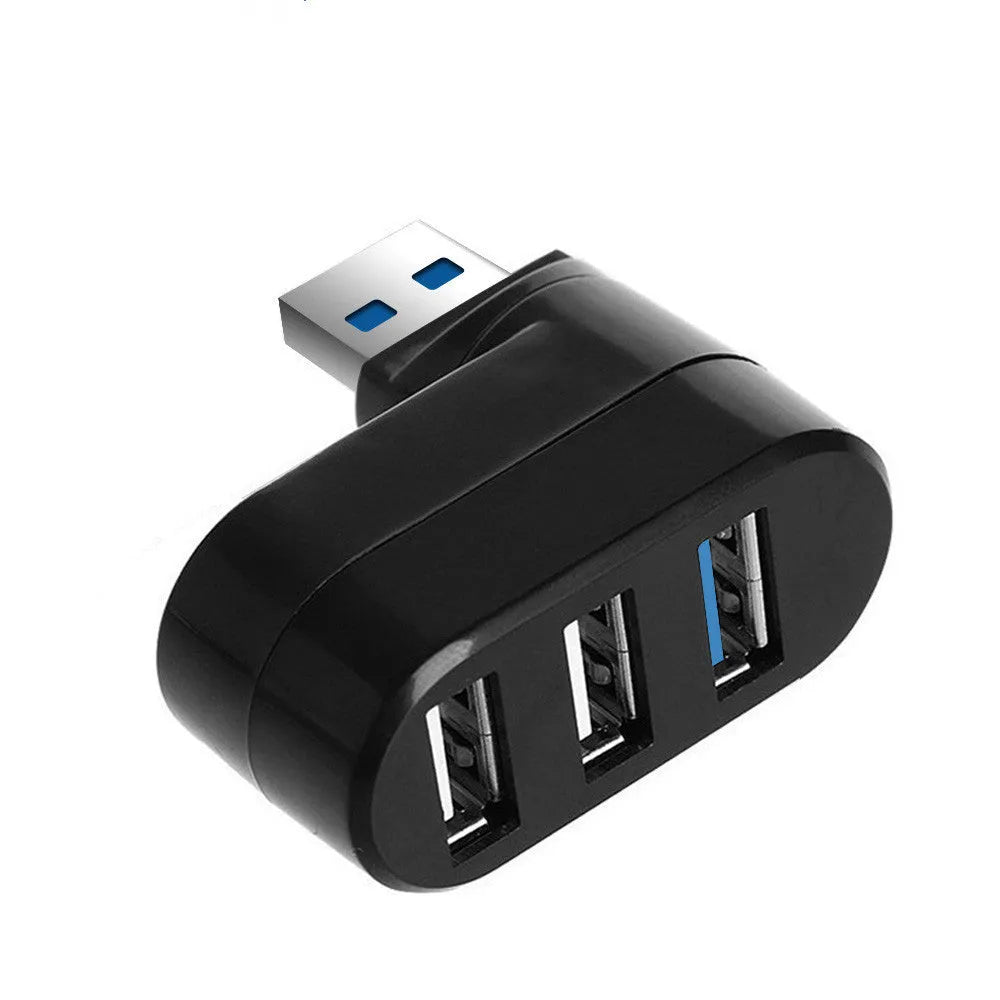Black and white USB 3.0 four-port rotary hub on a desk next to a laptop