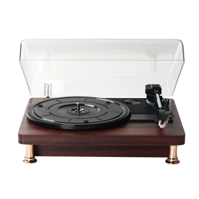 Retro vinyl record player with wood grain finish, transparent dust cover, and built-in speaker