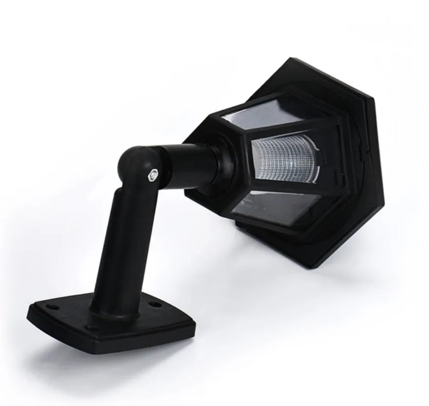 Black hexagonal solar-powered wall lamp for outdoor garden use.