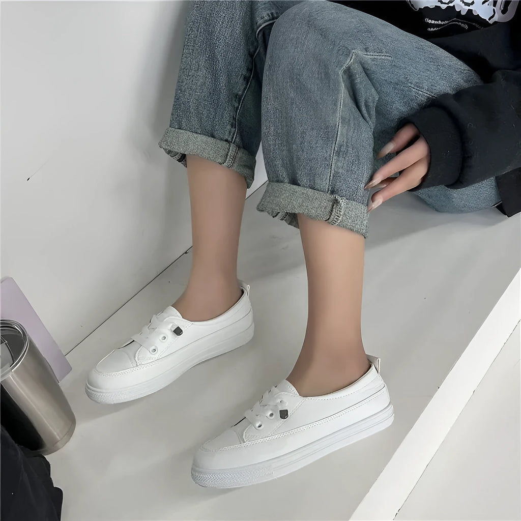 White women's sports breathable shoes with patent leather upper, flat heel, round toe, and front lace-up on a plain background