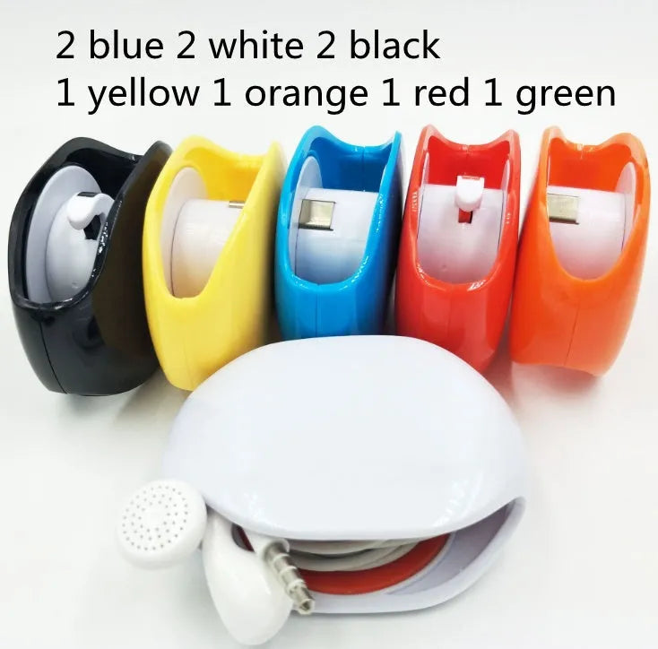 Compact automatic earphone winder in multiple colours on a grey background, showing extended cable.