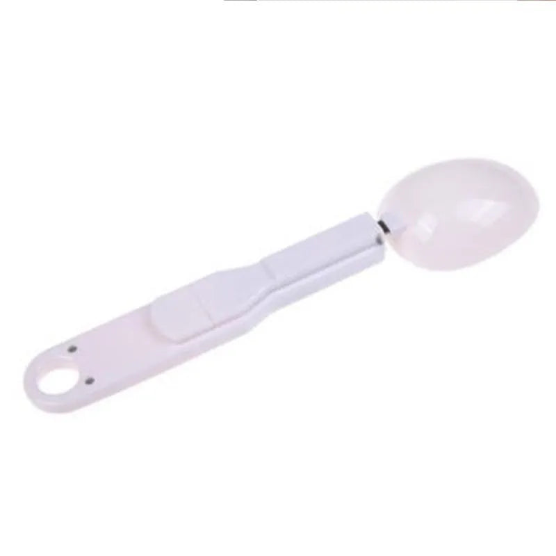 White digital kitchen spoon scale with LCD display showing weight measurement