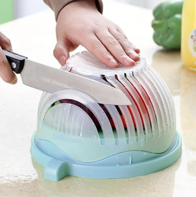 Blue salad cutter bowl with chopping lid and serving plate base on a kitchen counter
