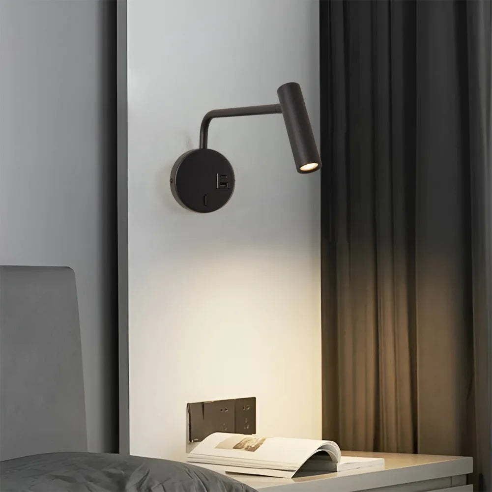 Black minimalist rocker reading wall lamp with LED light on a white wall