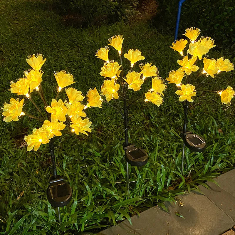 LED solar simulation camellia lawn lamp in garden setting, available in pink or yellow, IP65 rated, 720mm tall